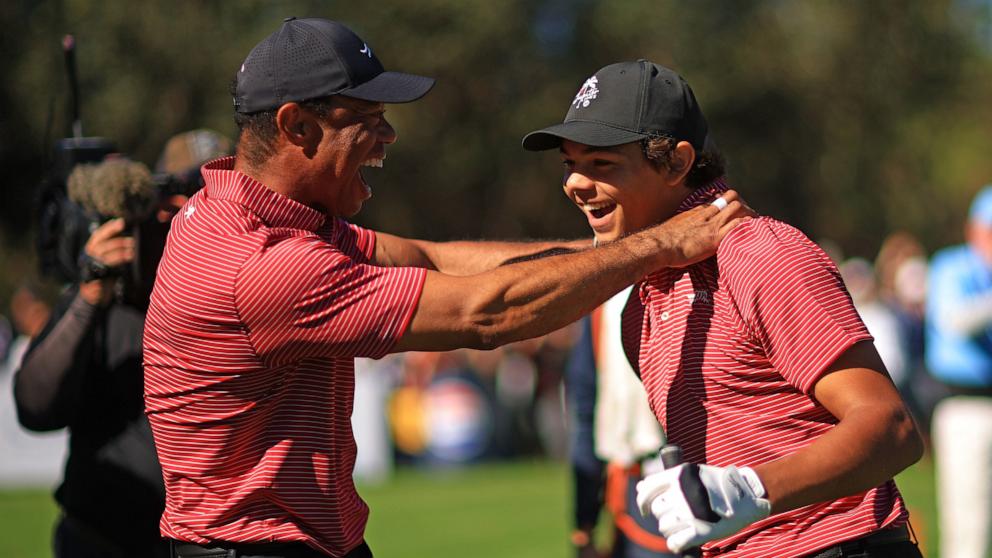 PHOTO: Tiger Woods of the United States reacts with his son Charlie Woods after making the first hole-in-one of his career on the fourth hole during the second round of the PNC Championship at Ritz-Carlton Golf Club on Dec. 22, 2024 in Orlando, Fla.