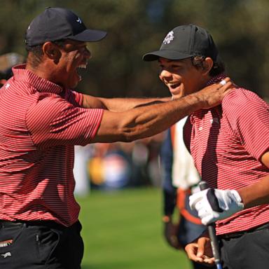 PHOTO: Tiger Woods of the United States reacts with his son Charlie Woods after making the first hole-in-one of his career on the fourth hole during the second round of the PNC Championship at Ritz-Carlton Golf Club on Dec. 22, 2024 in Orlando, Fla.
