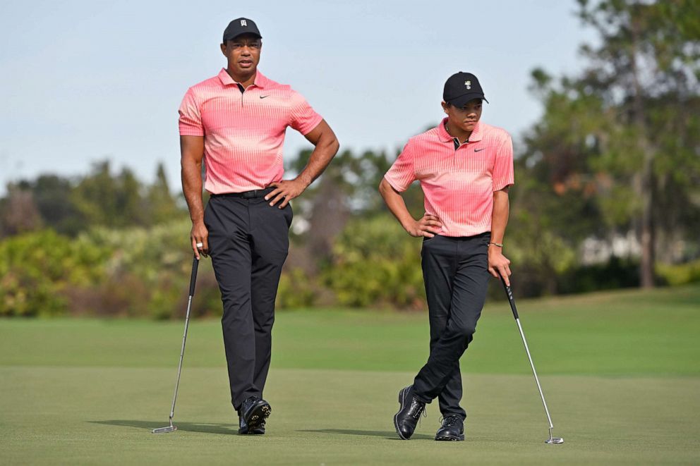 PHOTO: Tiger Woods and his son, Charlie Woods, stand together on the second green during a tournament, Dec. 17, 2022, in Orlando, Fla.