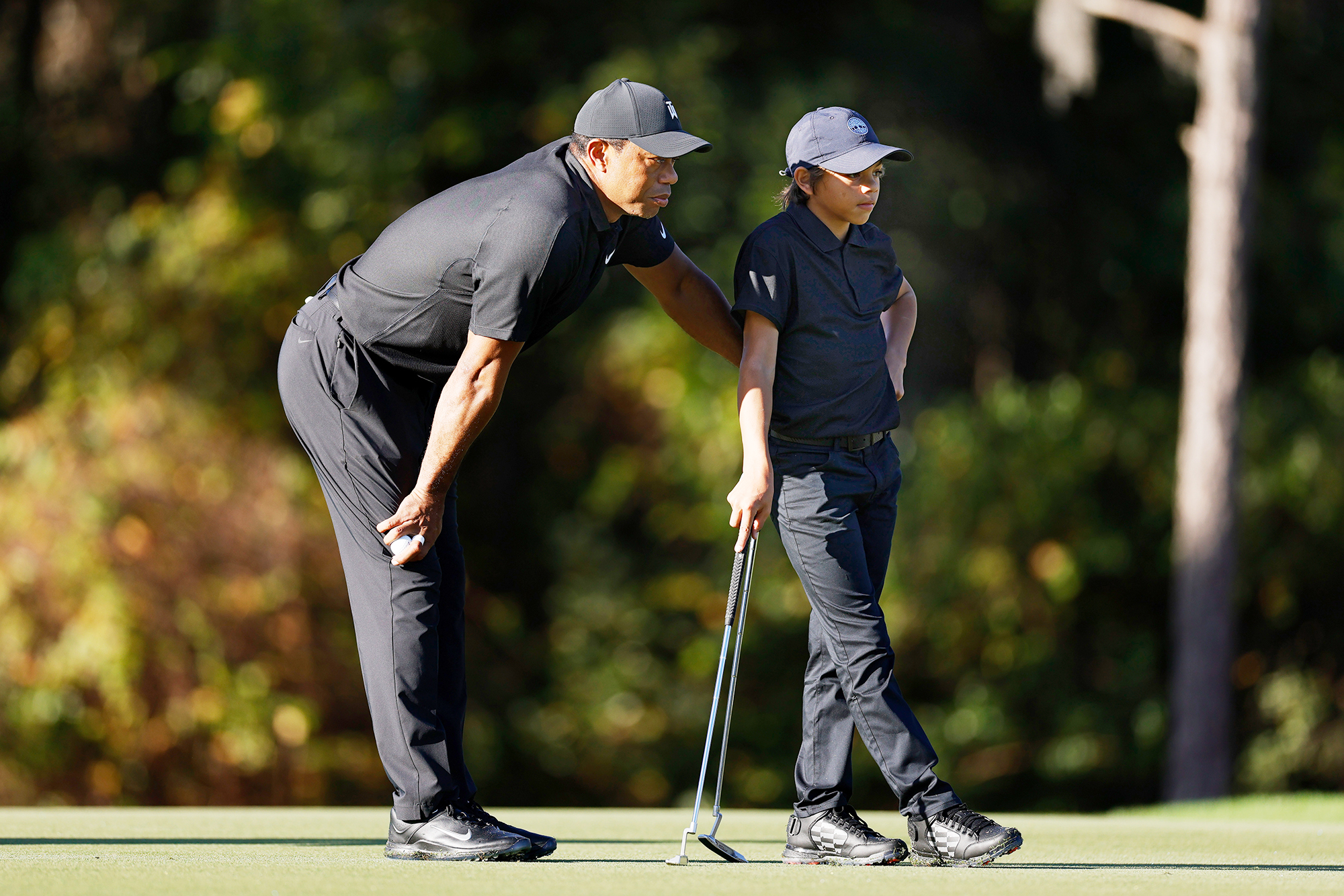 PHOTO: Tiger Woods and Charlie Woods look on during the Pro-Am ahead of the PNC Championship in Orlando, Fla., Dec. 17. 2021.