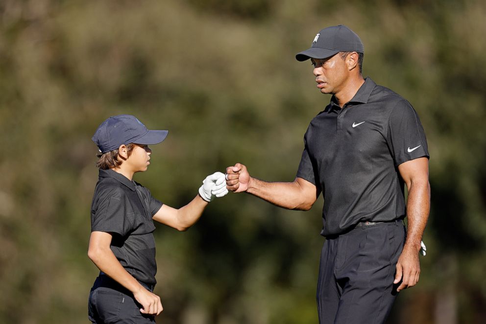 PHOTO: Tiger Woods and Charlie Woods fist bump during the Pro-Am ahead of the PNC Championship in Orlando, Fla., Dec. 17, 2021.