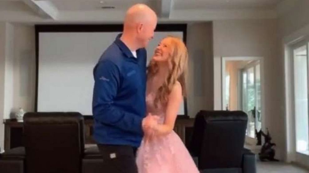 PHOTO: High school junior, Natalie Reese, dances with her dad, Bryan, in their living room after her prom at San Ramon Valley High School in Danville, Calif., was cancelled due to the coronavirus.