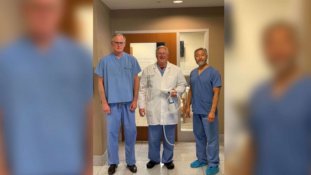 PHOTO: Dr. Todd Rumsey, center, holds the Cerene cryotherapy device used to help ease women's menstrual cycles.