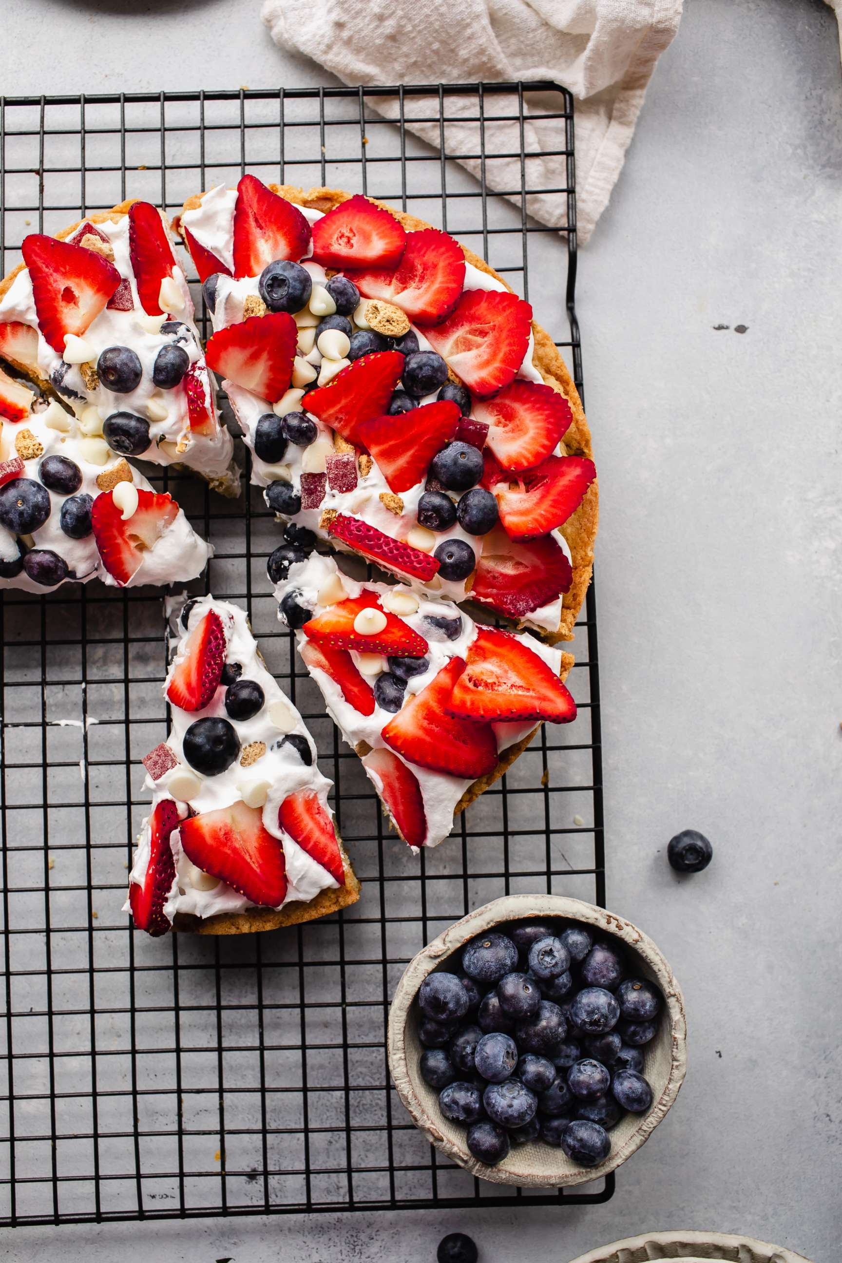 PHOTO: A baked dessert pizza with fresh berries and cream.