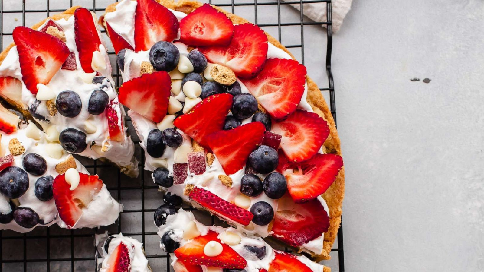 PHOTO: A baked dessert pizza with fresh berries and cream.