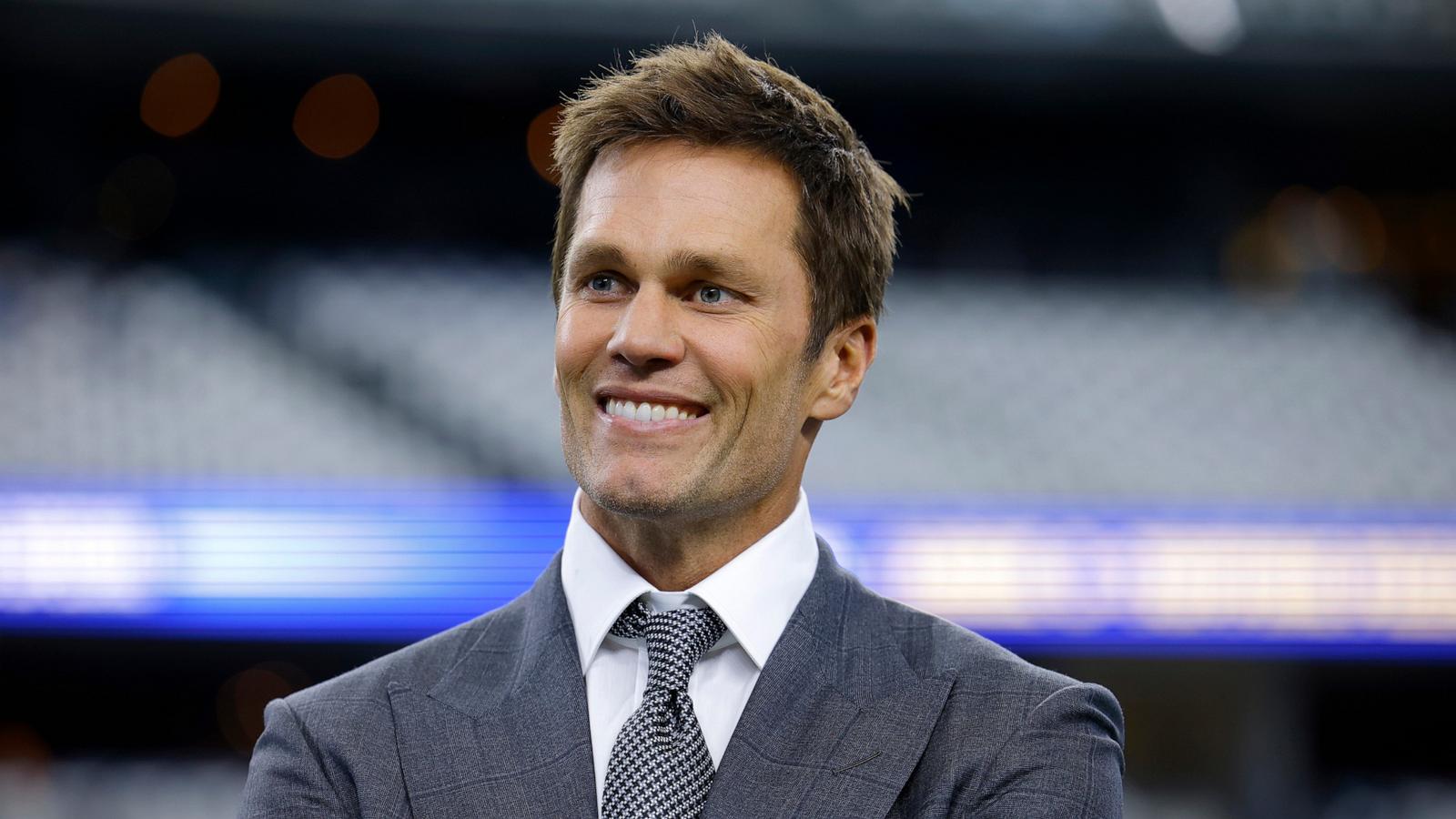 PHOTO: Fox Sports lead NFL analyst Tom Brady stands on the field during warmups before an NFL football game between the Detroit Lions and the Dallas Cowboys in Arlington, Texas, on Oct. 13, 2024.