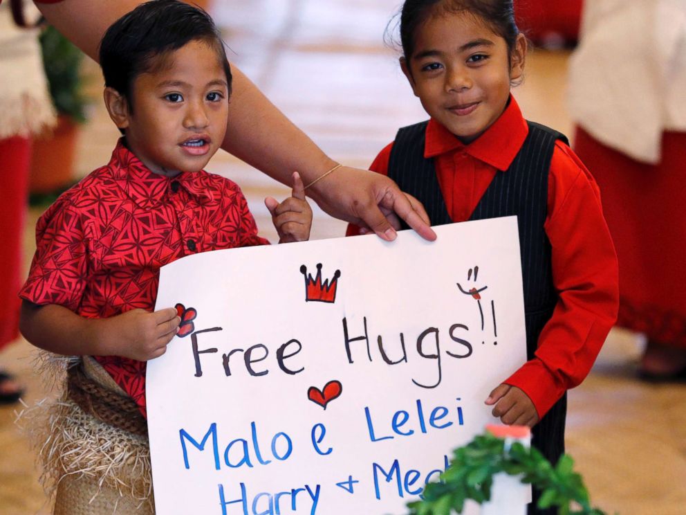 PHOTO: Children hold a placard as they await the arrival of Meghan, Duchess of Sussex and Prince Harry, Duke of Sussex for their meeting with Tonga Prime Minister in Nuku'alofa, Tonga, Oct. 26, 2018.