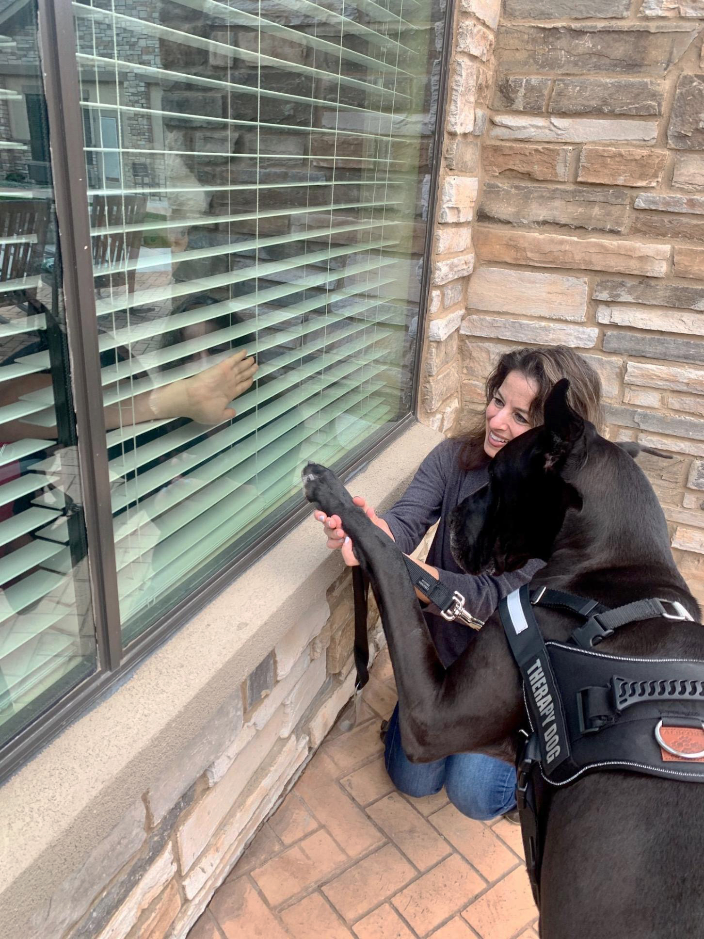PHOTO: Courtney Leigh takes her Great Dane Tonka to visit residents of Cedar Pointe Health & Wellness Suites on March 17, 2020, in Cedar Pointe, Texas.