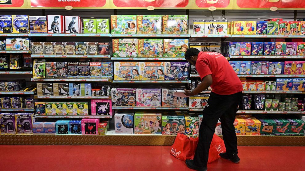 PHOTO: An employee arranges stock on the shelves at Hamley's toy store during a photo call in London, Oct. 14, 2021.