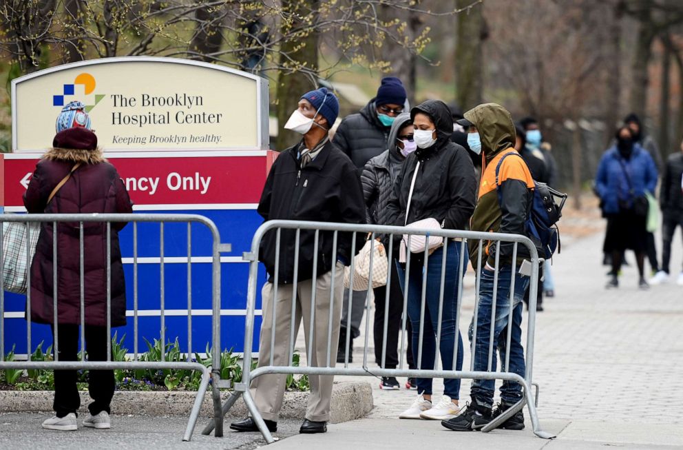 PHOTO: People who believe they have COVID-19, and who meet the criteria, wait in line to be pre-screened for the coronavirus outside of the Brooklyn Hospital Center in New York, March 20, 2020.