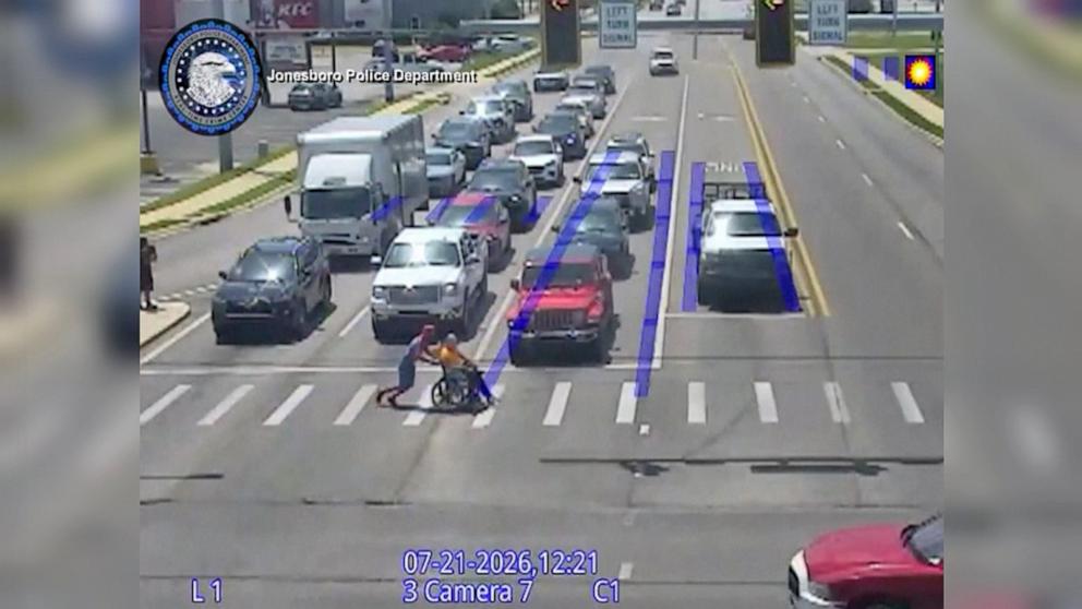 PHOTO: Christopher Hellenthal, who was dressed as Spider-Man, was caught on camera helping another man in a wheelchair cross the street on July 21, 2026.