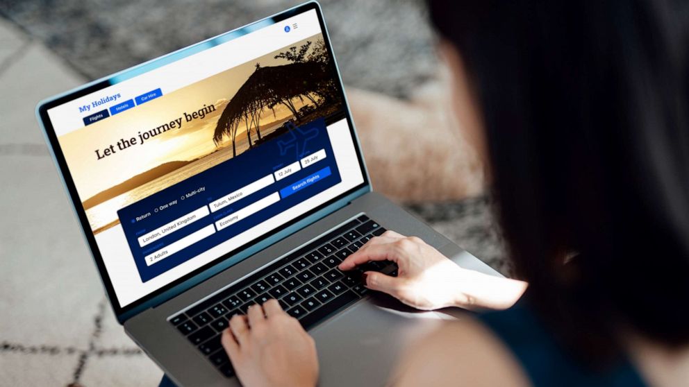 PHOTO: Stock photo of a woman booking a trip online.