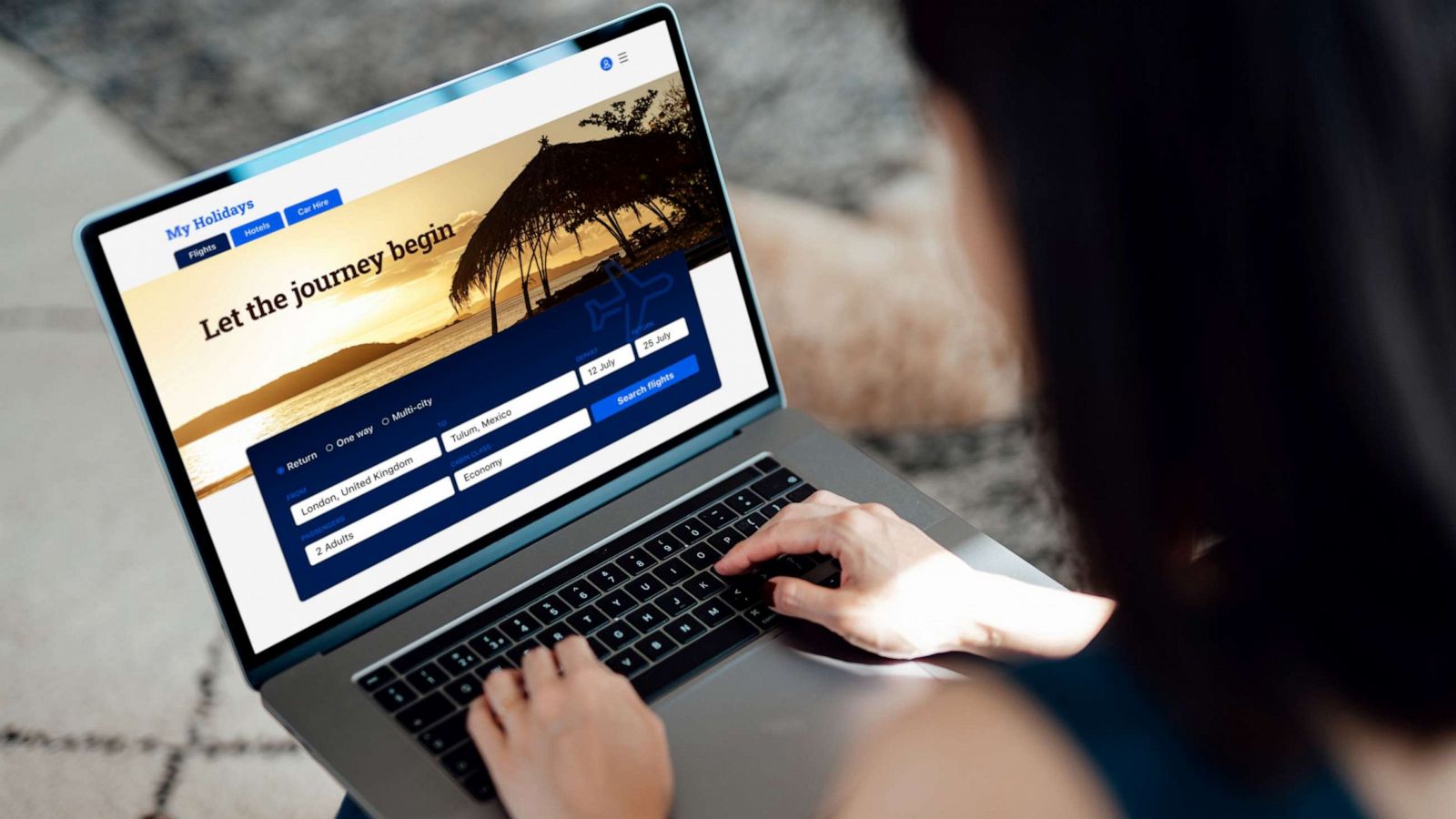 PHOTO: Stock photo of a woman booking a trip online.