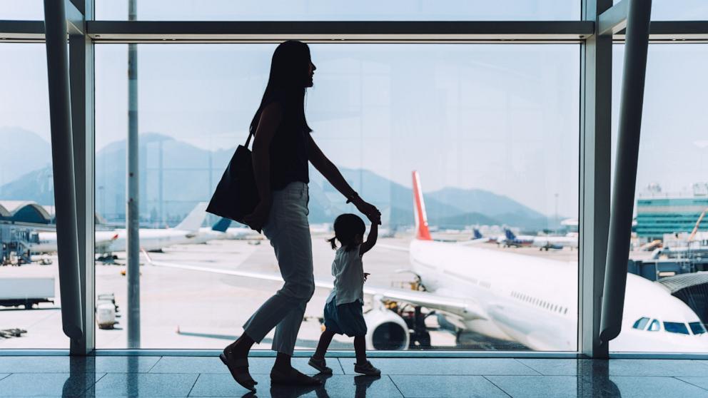 PHOTO: An undated stock photo of a woman with a child walking an an airport. 