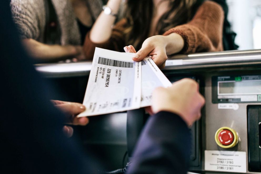 PHOTO: Travelers get their boarding passes at airline check-in counter in this undated stock photo.