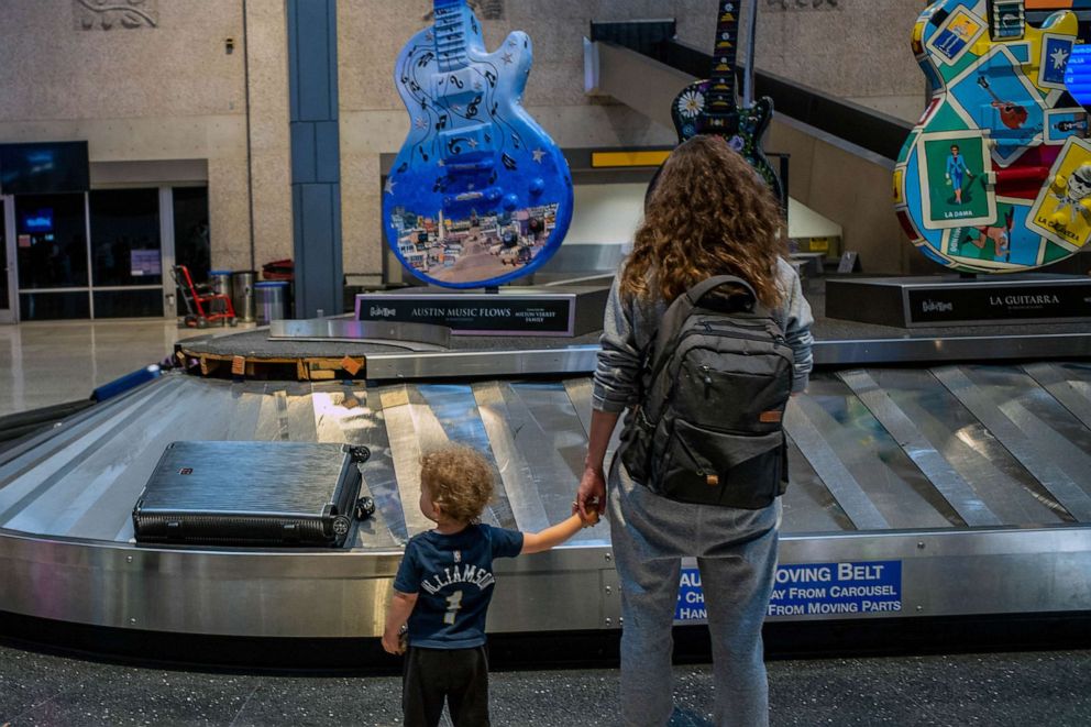 PHOTO: FILE - A family waits for their luggage at the Austin-Bergstrom International Airport, May 26, 2023 in Austin, Texas.