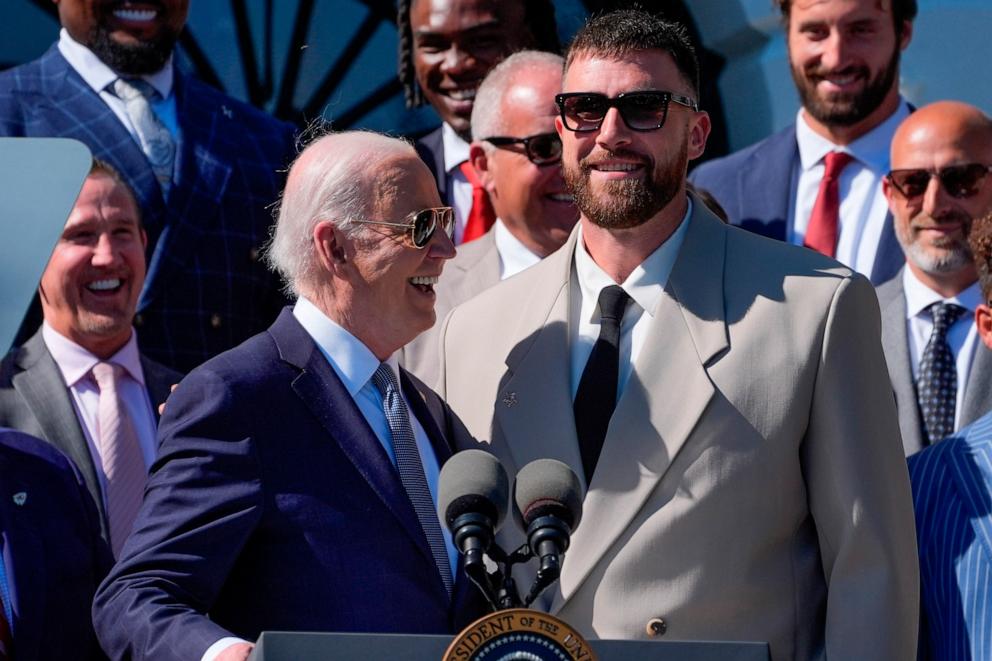 PHOTO: President Joe Biden, left, talks with Kansas City Chiefs tight end Travis Kelce, right, during an event with the Super Bowl-champion Kansas City Chiefs on the South Lawn of the White House, May 31, 2024.
