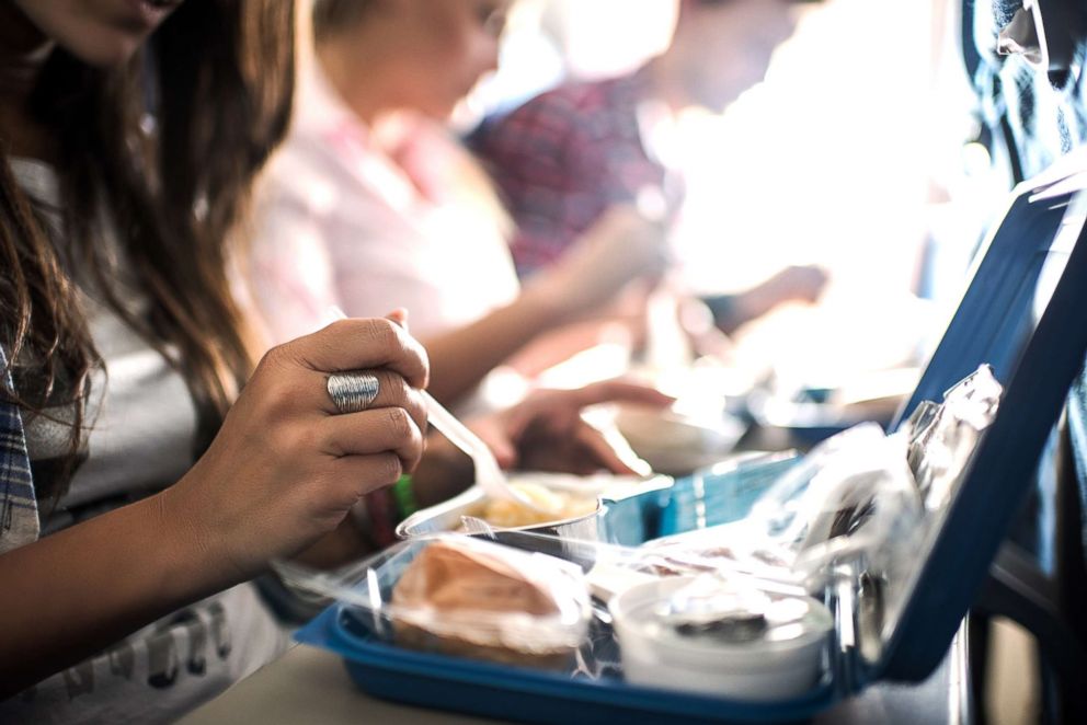 PHOTO: Travelers have a meal while on an airplane.