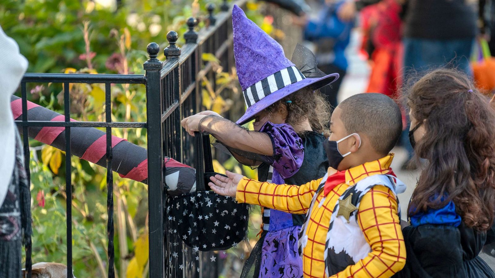 PHOTO: Children receive treats by candy chutes while trick-or-treating for Halloween in Woodlawn Heights on Oct. 31, 2020 in New York City.