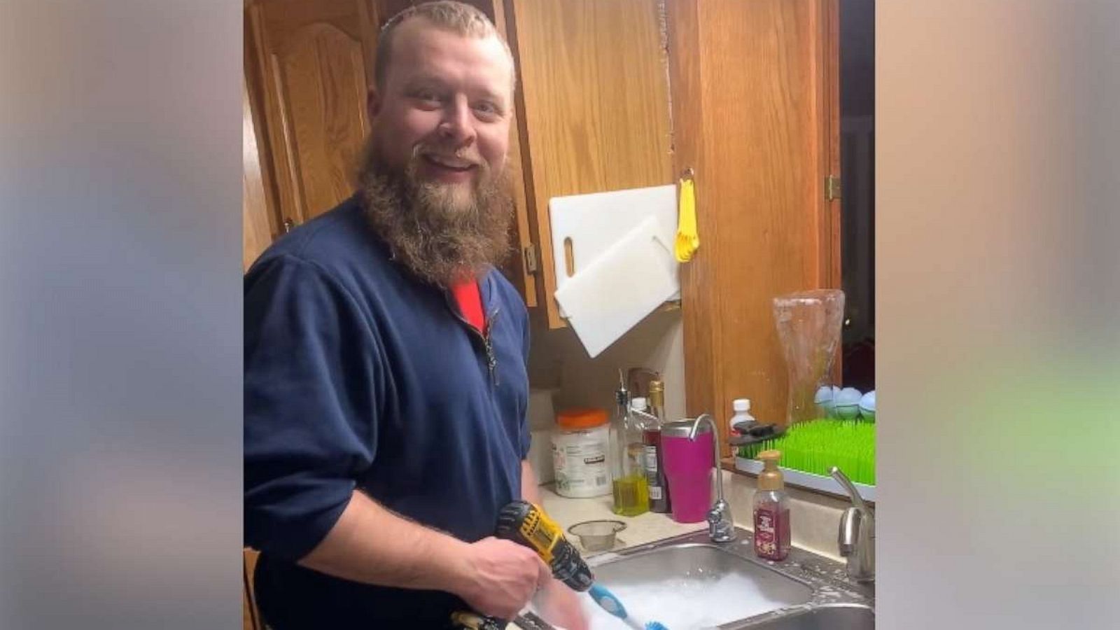 PHOTO: Aerol Peterson, proud dad to Natashia, Arya and Trae, 7 months, from Lincoln, Nebraska, was recorded by his wife Christy as he washed the bottled using a power drill.