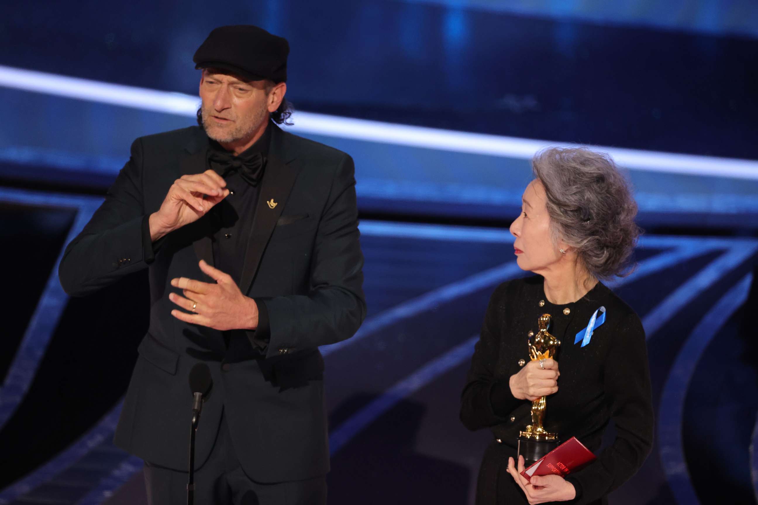 PHOTO: Troy Kotsur accepts the Actor in a Supporting Role award for "CODA" from Youn Yuh-jung onstage during the 94th Annual Academy Awards at Dolby Theatre on March 27, 2022 in Hollywood, Calif.