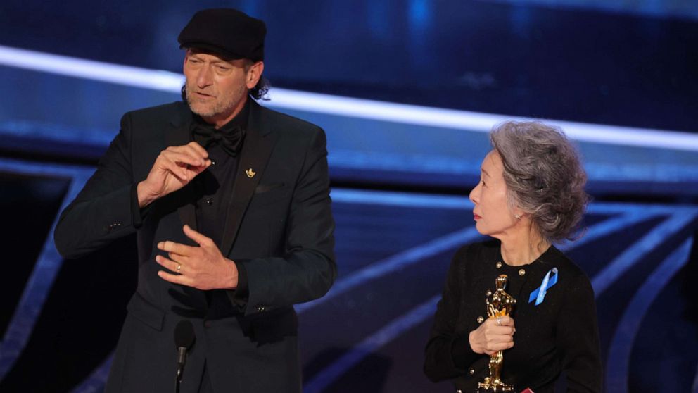 PHOTO: Troy Kotsur accepts the Actor in a Supporting Role award for "CODA" from Youn Yuh-jung onstage during the 94th Annual Academy Awards at Dolby Theatre on March 27, 2022 in Hollywood, Calif.