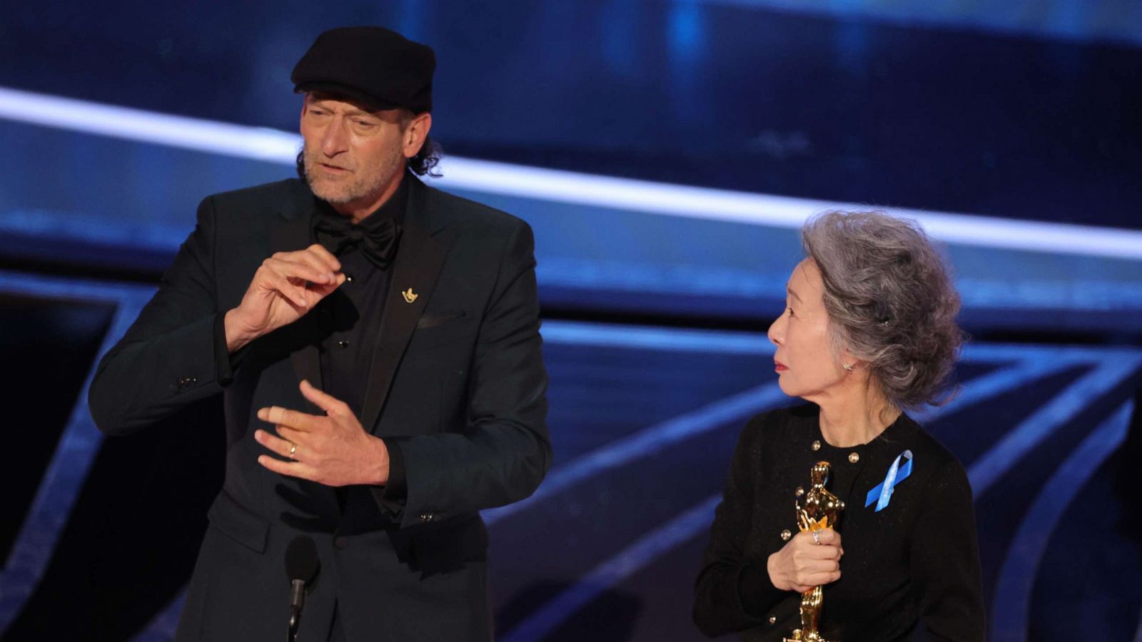 PHOTO: Troy Kotsur accepts the Actor in a Supporting Role award for "CODA" from Youn Yuh-jung onstage during the 94th Annual Academy Awards at Dolby Theatre on March 27, 2022 in Hollywood, Calif.