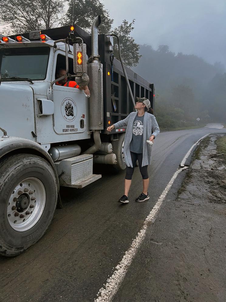 PHOTO: Heather Smith, North Carolina's 2024 teacher of the year, speaks with a repairman working in her hometown of Waynesville, N.C., after Hurricane Helene.