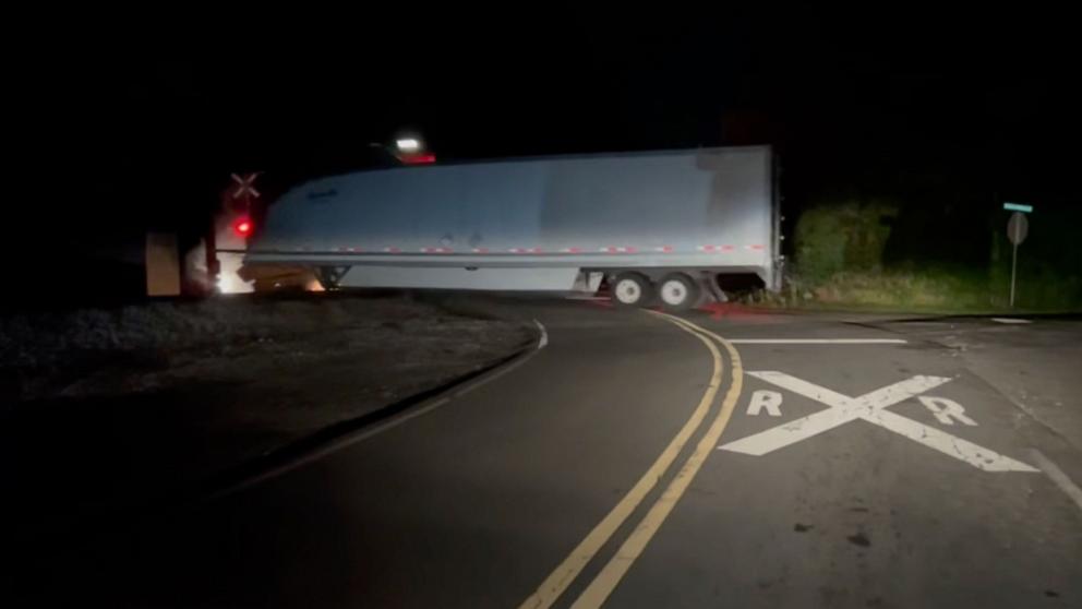 PHOTO: A tractor-trailer driver narrowly escaped a train collision in Georgia.