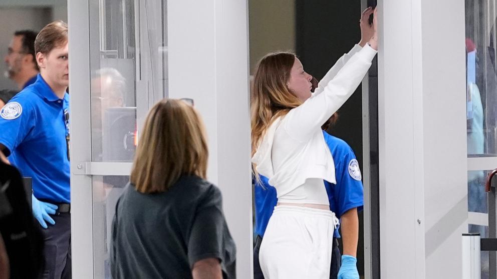 PHOTO: A passenger is screened by TSA at Love Field Airport in Dallas, Aug. 30, 2024.