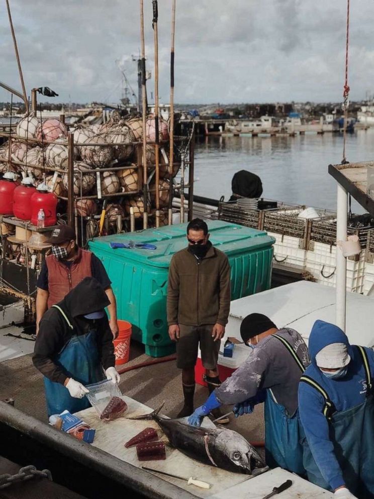 PHOTO: Fisherman portion off tuna steaks fresh on the docks in San Diego, California.