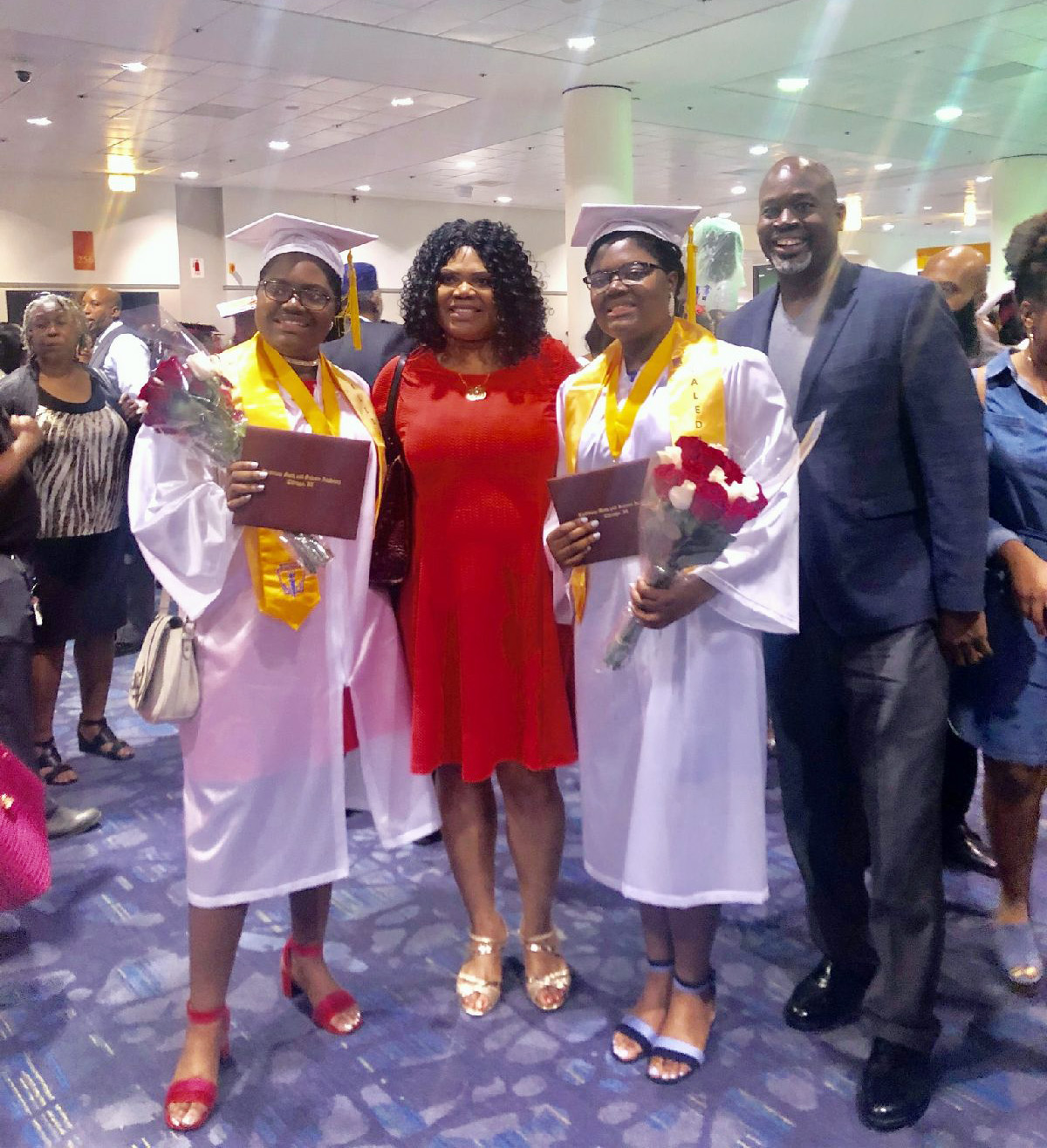 PHOTO: Tyra and Tia Smith, 18, are seen with their parents, Lemi-Ola Erinkitola and Terry Smith Sr. at the Lindblom Math and Science Academy graduation in West Englewood, Ill., on June 8, 2019.