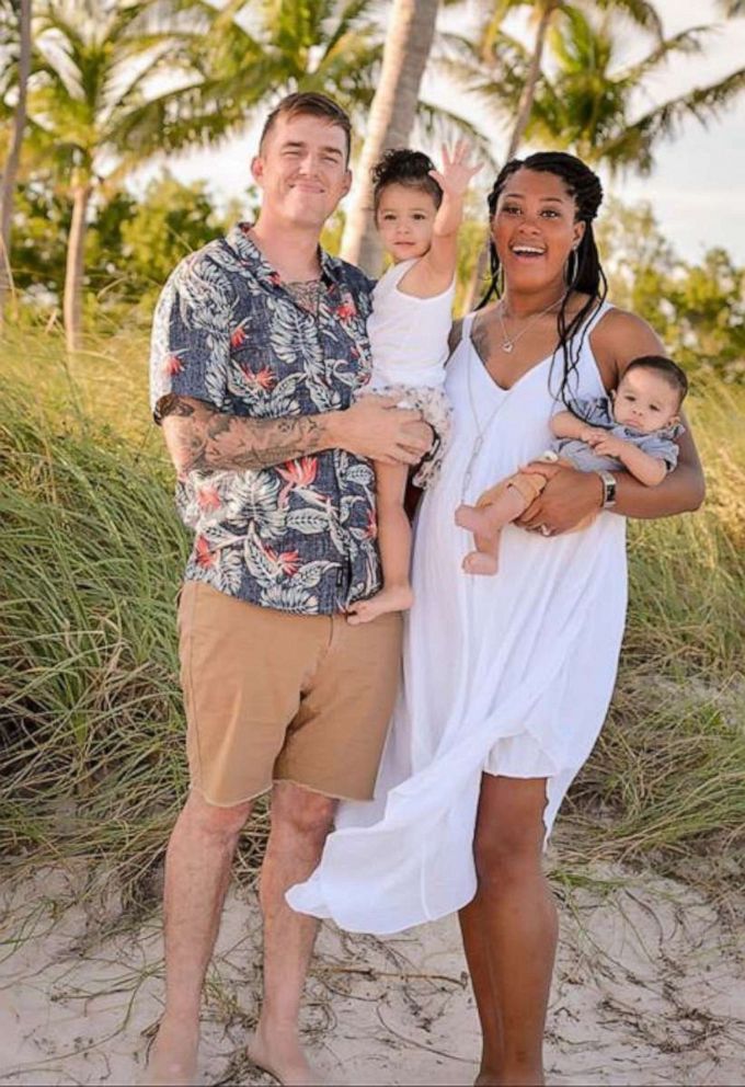 PHOTO: Kileah and Samuel Junker pose with adopted children Zayla and Zymanni while Kileah is pregnant with twins.