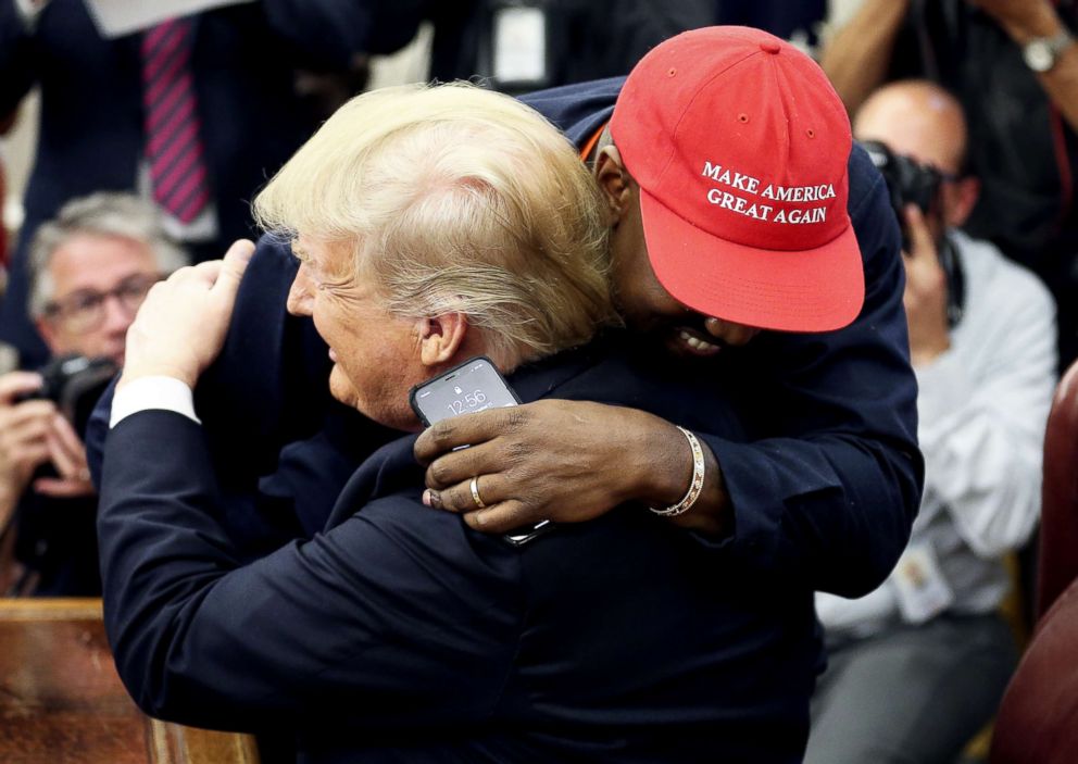 PHOTO: President Donald Trump hugs rapper Kanye West during a meeting in the Oval office of the White House on Oct. 11, 2018 in Washington, D.C.