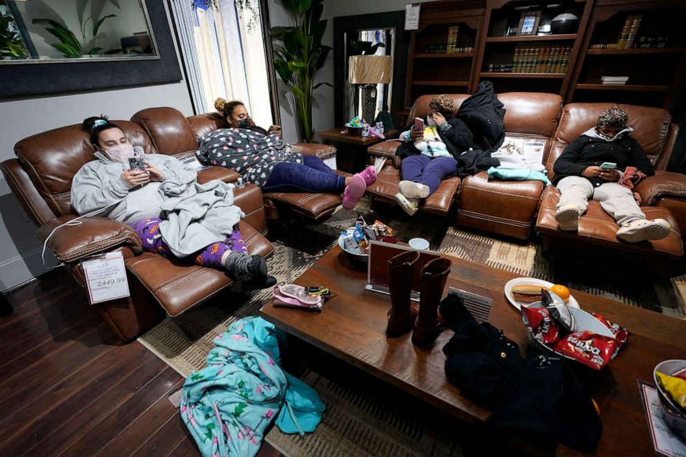 PHOTO: People with no power at their homes rest inside a Gallery Furniture store after the owner opened the business as a shelter on Feb. 16, 2021, in Houston. More than 4 million people in Texas lost power after snowfall and single-digit temperatures.