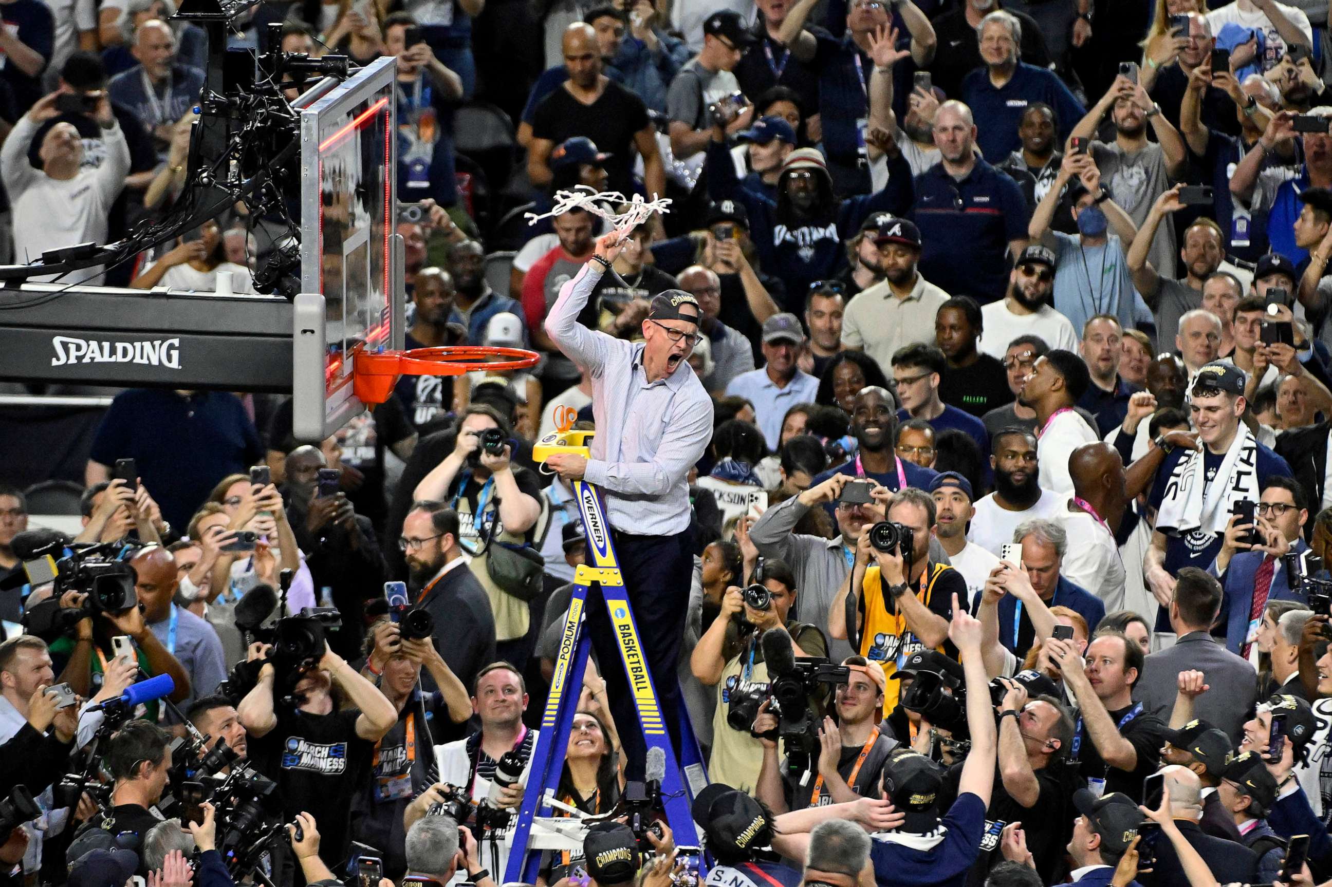 PHOTO: Head coach Dan Hurley of the Connecticut Huskies reacts as he cuts down the net after defeating the San Diego State Aztecs 76-59 during the NCAA Men's Basketball Tournament National Championship game at NRG Stadium, April 03, 2023 in Houston.
