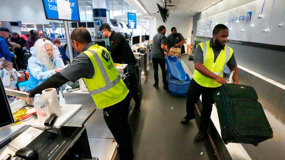 PHOTO: In this Dec. 21, 2023 file photo, passengers drop off their baggage at the George Bush Intercontinental Airport in Houston. 