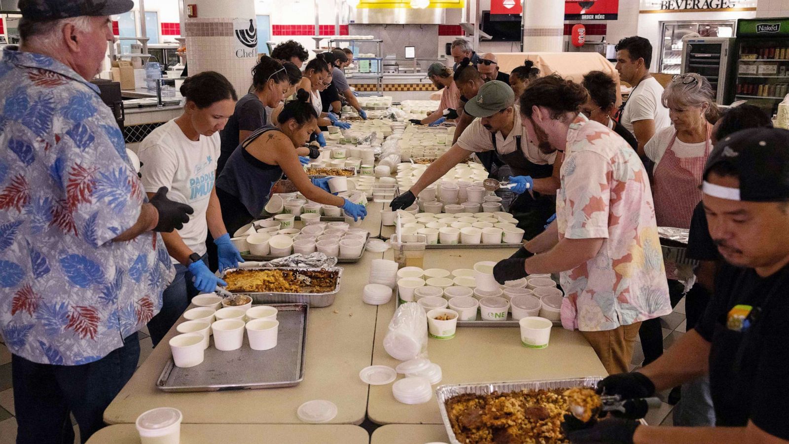 PHOTO: Volunteers prepare free meals to donate to west Maui families affected by wildfires, at the University of Hawaii Maui College in Kahului, central Maui, Hawaii, Aug. 13, 2023.