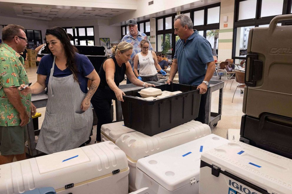 PHOTO: Volunteers prepare free meals to go to west Maui families affected by wildfires, at the University of Hawaii Maui College in Kahului, central Maui, Hawaii on Aug. 13, 2023.