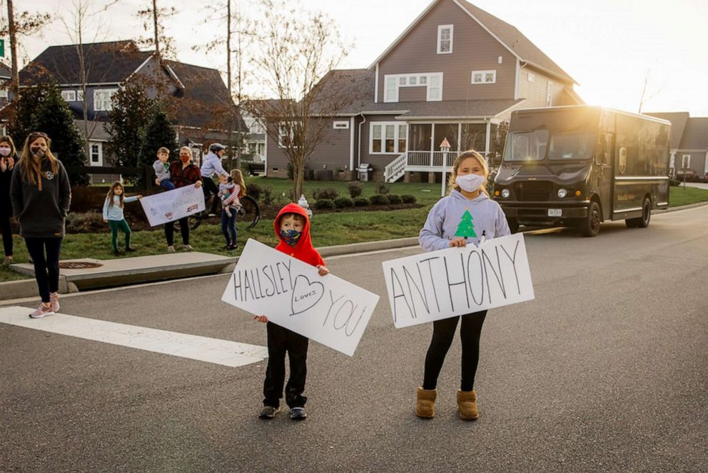 PHOTO:  Kids in the Hallsey neighborhood of Chesterfield County, Virginia, hold up signs thanking UPS delivery driver Anthony Gaskins for all the work he's done during the pandemic.