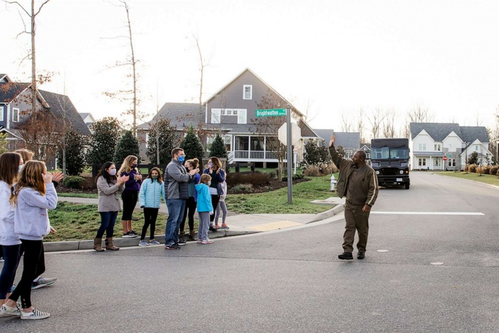 PHOTO: UPS delivery driver Anthony Gaskins waves at Hallsey neighborhood residents in Chesterfield County, Virginia, after they surprised him on his route.