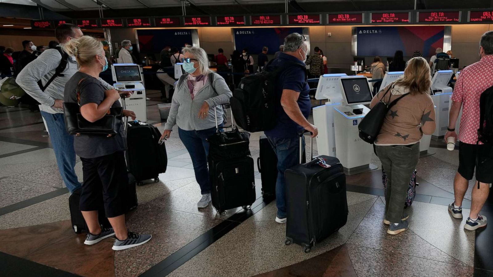 PHOTO: Travellers wait to approach the ticketing counter for Delta Airlines in Denver International Airport, Sept. 14, 2021, in Denver.