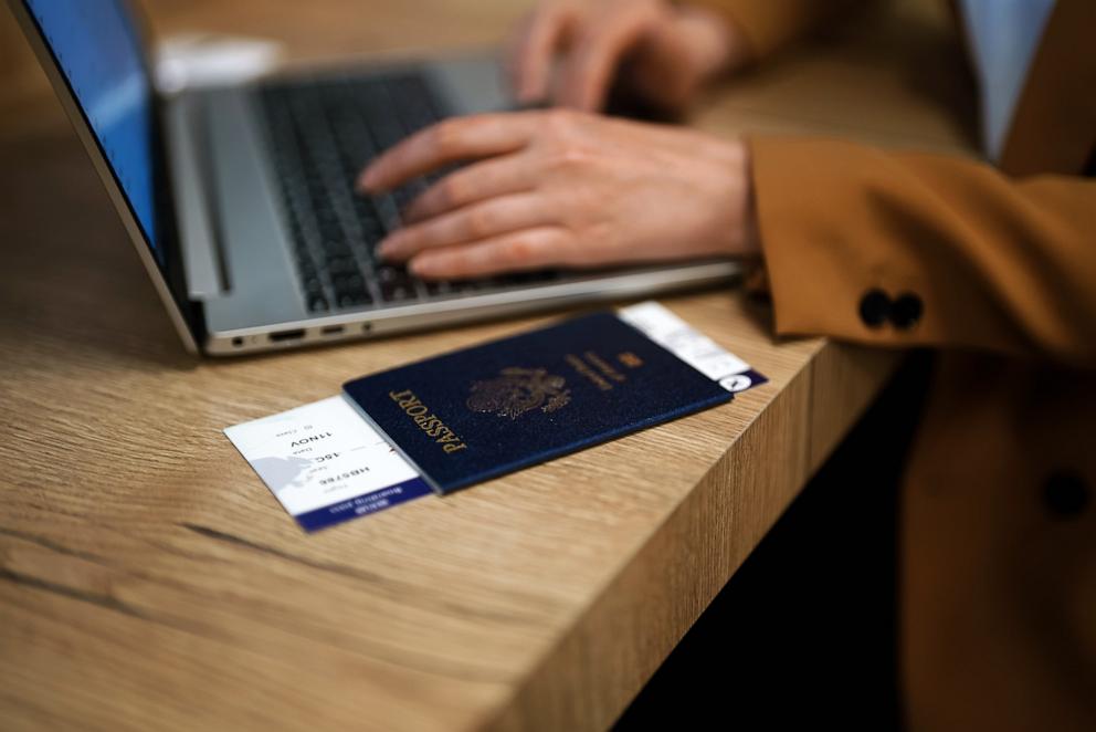 PHOTO: A woman with a U.S. passport waits for her flight while working on her laptop.