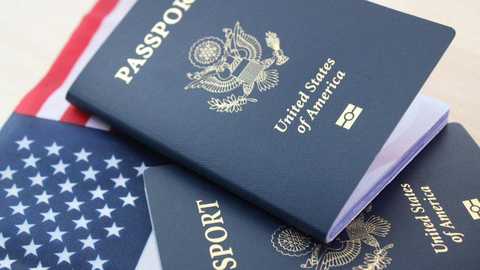 PHOTO: Close up of U.S. passports on an American flag.