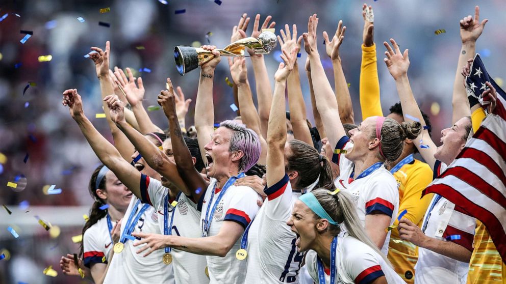 PHOTO: Megan Rapinoe of the USA lifts the FIFA Women's World Cup Trophy following her team's victory in the 2019 FIFA Women's World Cup France Final match between The U.S. and The Netherlands at Stade de Lyon on July 07, 2019, in Lyon, France.