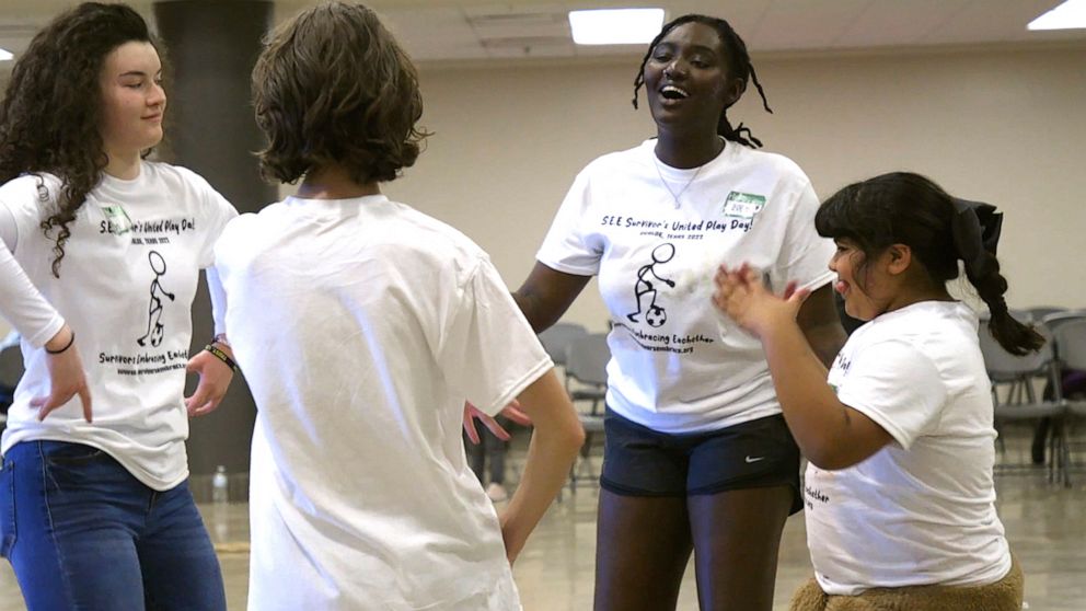 PHOTO: Zoe Touray, center, interacts with attendees at Survivors United Playday in Uvalde, Texas on November 19, 2022.