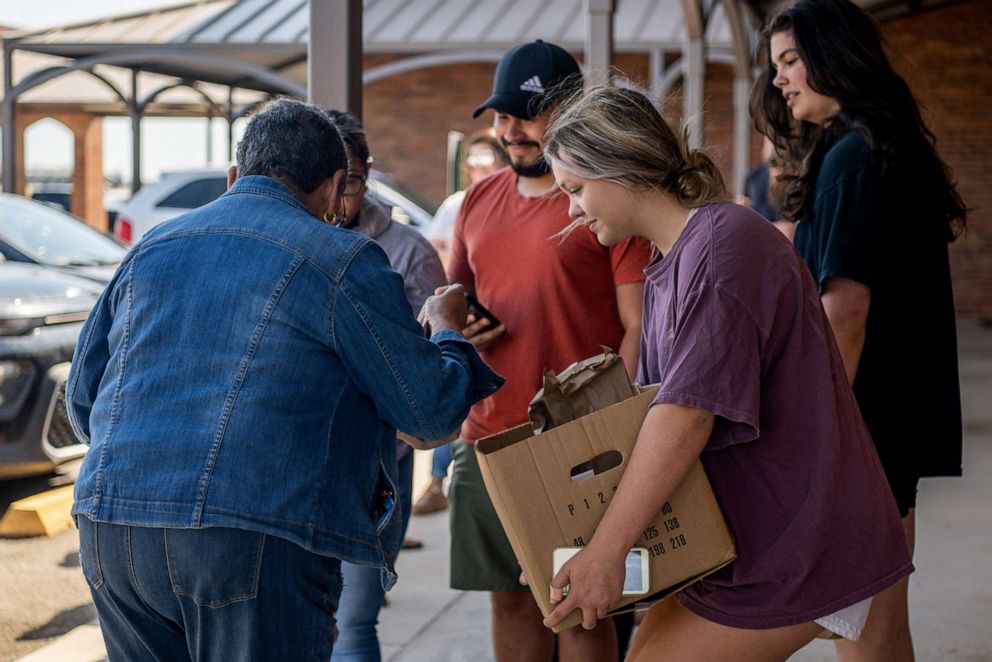 PHOTO: Community members distribute food to people waiting to donate blood at the South Texas Blood Bank's emergency blood drive on May 25, 2022 in Uvalde, Texas.