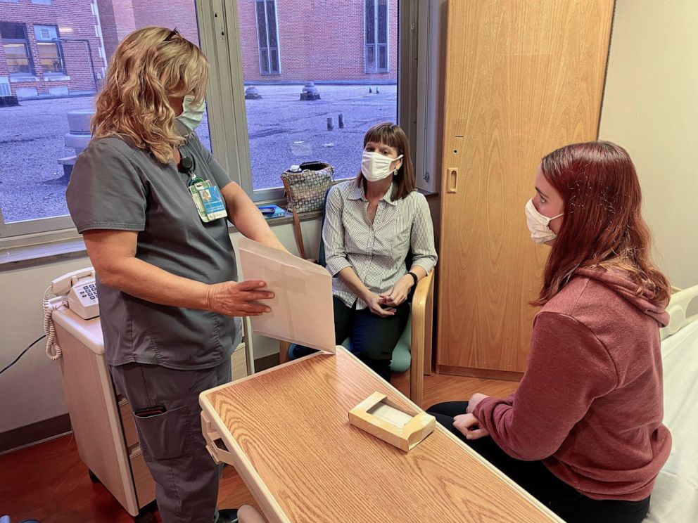 PHOTO: Clinical research coordinator Stacy Ranz discusses procedures with Katelyn Evans, 16, and her mom Laurie Evans ahead of injection in Pfizer COVID-19 vaccine trial.