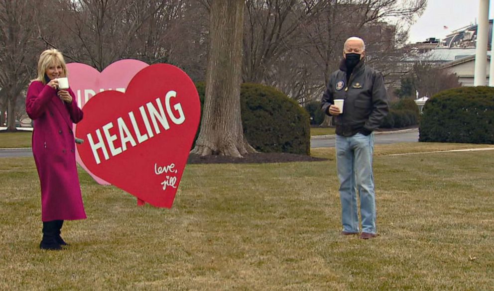 PHOTO: First lady Jill Biden and President Joe Biden look at the Valentines Jill Biden had installed overnight on the White House lawn, early Feb. 12, 2021.