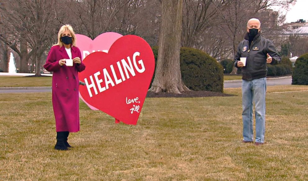 PHOTO: First lady Jill Biden and President Joe Biden look at the Valentines Jill Biden had installed overnight on the White House lawn, early Feb. 12, 2021.